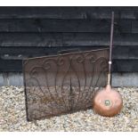 An antique copper warming pan and fire guard