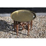 A Middle Eastern brass tray top table