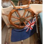 A wooden ship's wheel with turned spokes