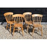 A harlequin set of six beech saddle seated kitchen dining chairs