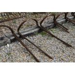 A set of ten weathered steel curved garden plant supports, 100 cm high