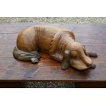 A large carved wood sleeping dog