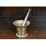 An antique bell-metal pestle and mortar