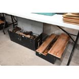 A steel trunk containing vintage tools