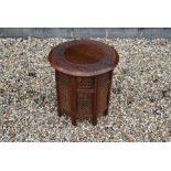 An Indian carved hardwood circular occasional table