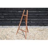 A vintage stained pine folding easel to/w a pair of Regency style chairs