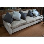 A contemporary three seater sofa, 250 cm wide