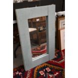 A rustic light blue painted hardwood wall mirror