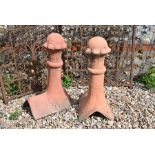 A pair of reconstituted stone Victorian style ball finial ridge tiles in aged terracotta finish, 56