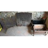 Two old cast iron fire backs to/with two fire baskets and a brass folding spark guard (4)