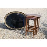 A 19th century oval wall mirror in decoratively carved foliate gilt and ebonised frame,
