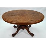 A Victorian walnut oval tilt top breakfast table