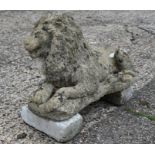 Large weathered cast stone recumbent garden lion