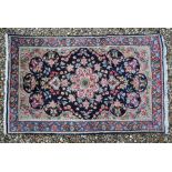 A Persian Kerman rug, 140 cm x 90 cm