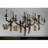 A set of four gilt ormolu rococo style twin arm wall sconces