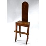 An antique fruitwood correction chair