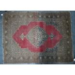 An antique Persian rug, heavy wear, pale crimson ground