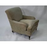 A Howard style easy armchair, in pale green upholstery