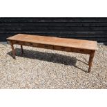 An antique pine long hall table, the wide two plank top over five short frieze drawers