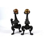 A pair of antique cast iron brass ball finial fire dogs