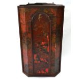 An 18th century red chinoiserie decorated hanging corner cupboard