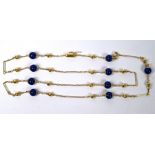 A yellow metal and lapis lazuli bead necklace