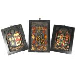 Three antique relief-carved and painted armorial panels