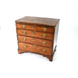 A George III mahogany chest of four long graduated cock-beaded drawers