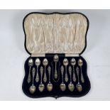 Cased set of twelve silver coffee spoons with tongs