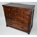 An antique oak chest of two short over three long graduated drawers