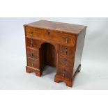 A George III feather-banded mahogany kneehole desk