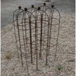 A set of six weathered steel ball-head garden obelisks