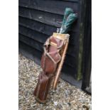 A vintage set of golf clubs with steel handles