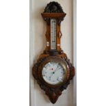 A Victorian walnut wheel barometer