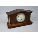 An inlaid walnut small mantle clock with French movement