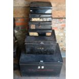 A stack of six old black tin deeds boxes, various sizes and stencilled labels
