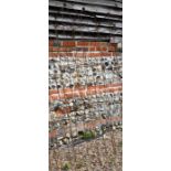 A pair of weathered steel ball-head garden obelisks