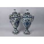 A pair of porcelain garniture urns and covers