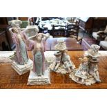 Two pairs of Continental porcelain figural candlesticks