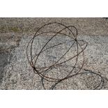 A weathered steel armillary sphere garden feature of plant frame, 65 cm high