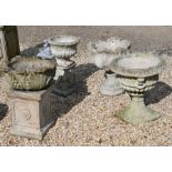 Four assorted weathered stone-cast garden urn planters, on plinth bases