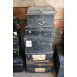 A stack of five old assorted sized black tin deed boxes, variously stencilled