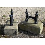 A companion pair of Victorian cast iron boot scrapers, mounted to stone bases