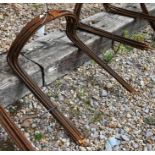 A set of ten weathered steel curved garden plant frames