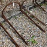 A set of ten weathered steel curved garden plant frames