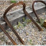 A set of ten weathered steel curved garden plant frames