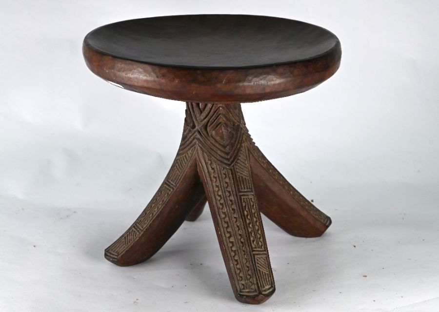 An old carved hardwood tripod stool of African origin