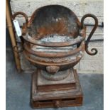 An antique cast iron fire basket in the form of a vase / brazier