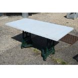 A solid marble top garden table on green painted cast iron base