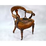 An antique mahogany open armchair